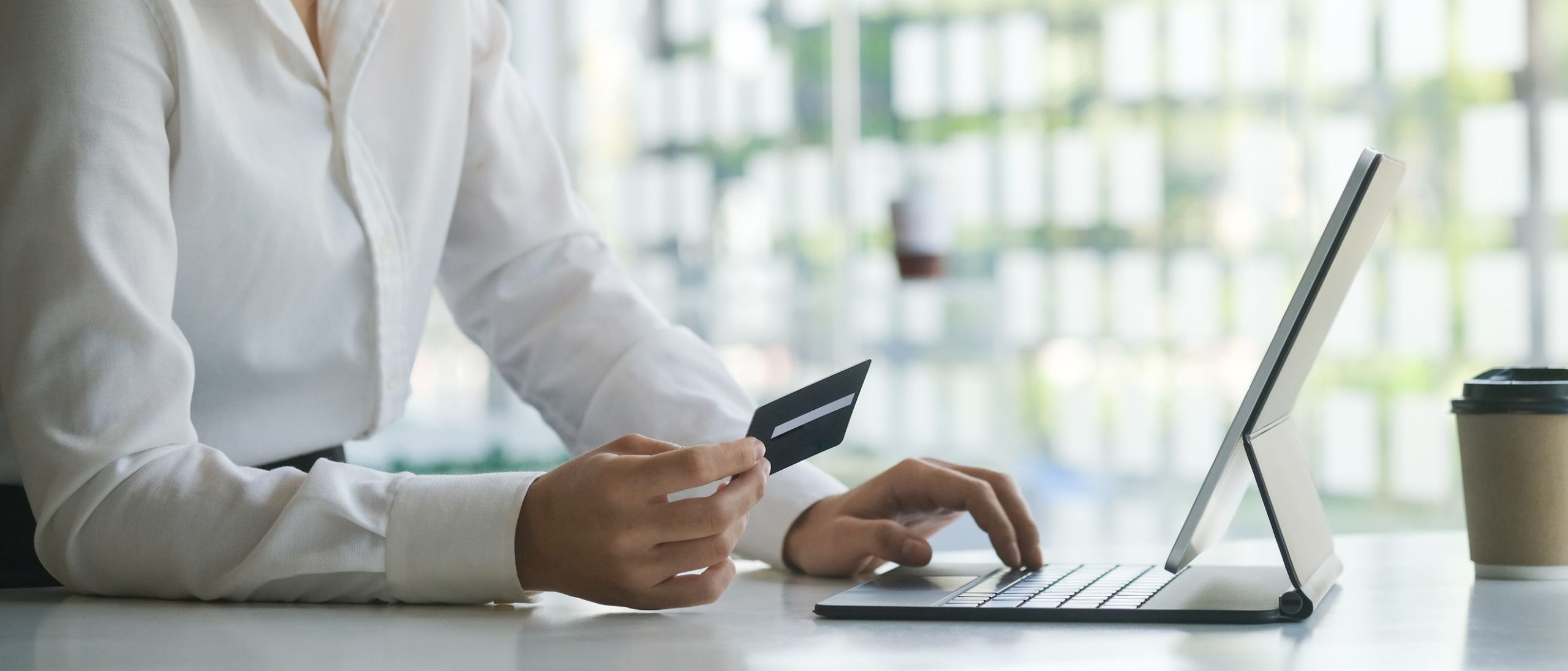 Person using card and computer.