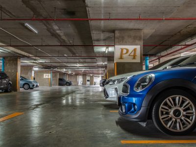 Bangkok, Thailand - 30 Jun 2021 : Row of different cars parked in Residential apartment building at workday. Full car park with parked cars. People stay at home during COVID-19 pandemic, Copy space, Selective focus.