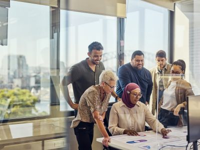 Teamwork and collaboration in a tech-driven Australian office with stunning Sydney views.